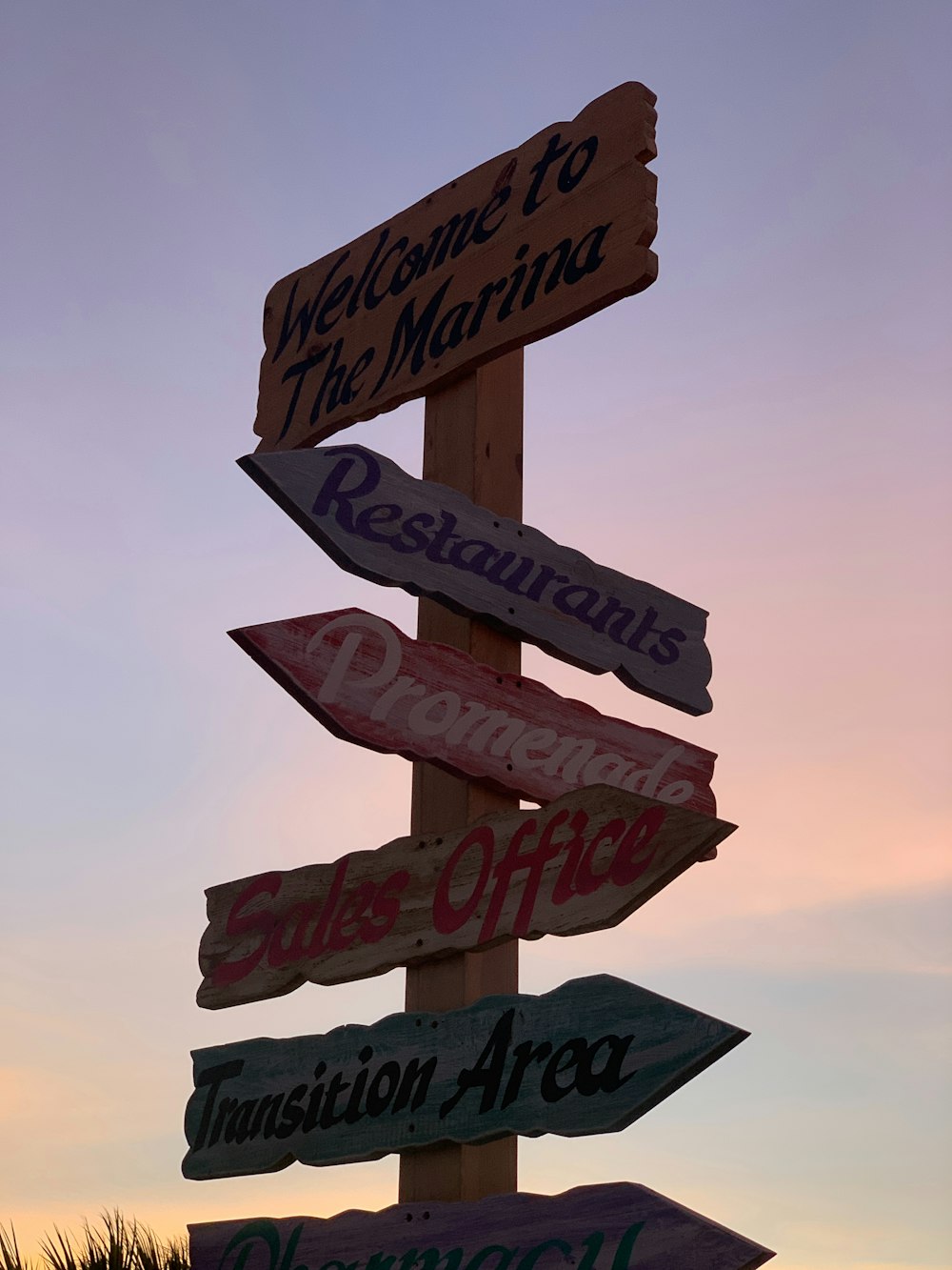 a wooden sign with many different signs on it