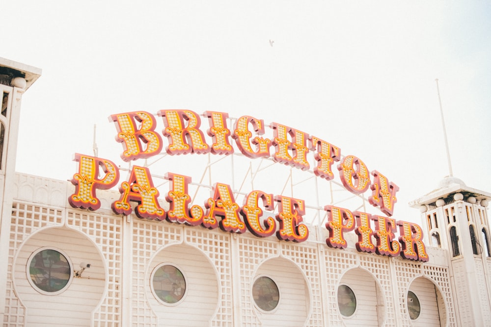 a sign that says brighton palace theatre on top of a building