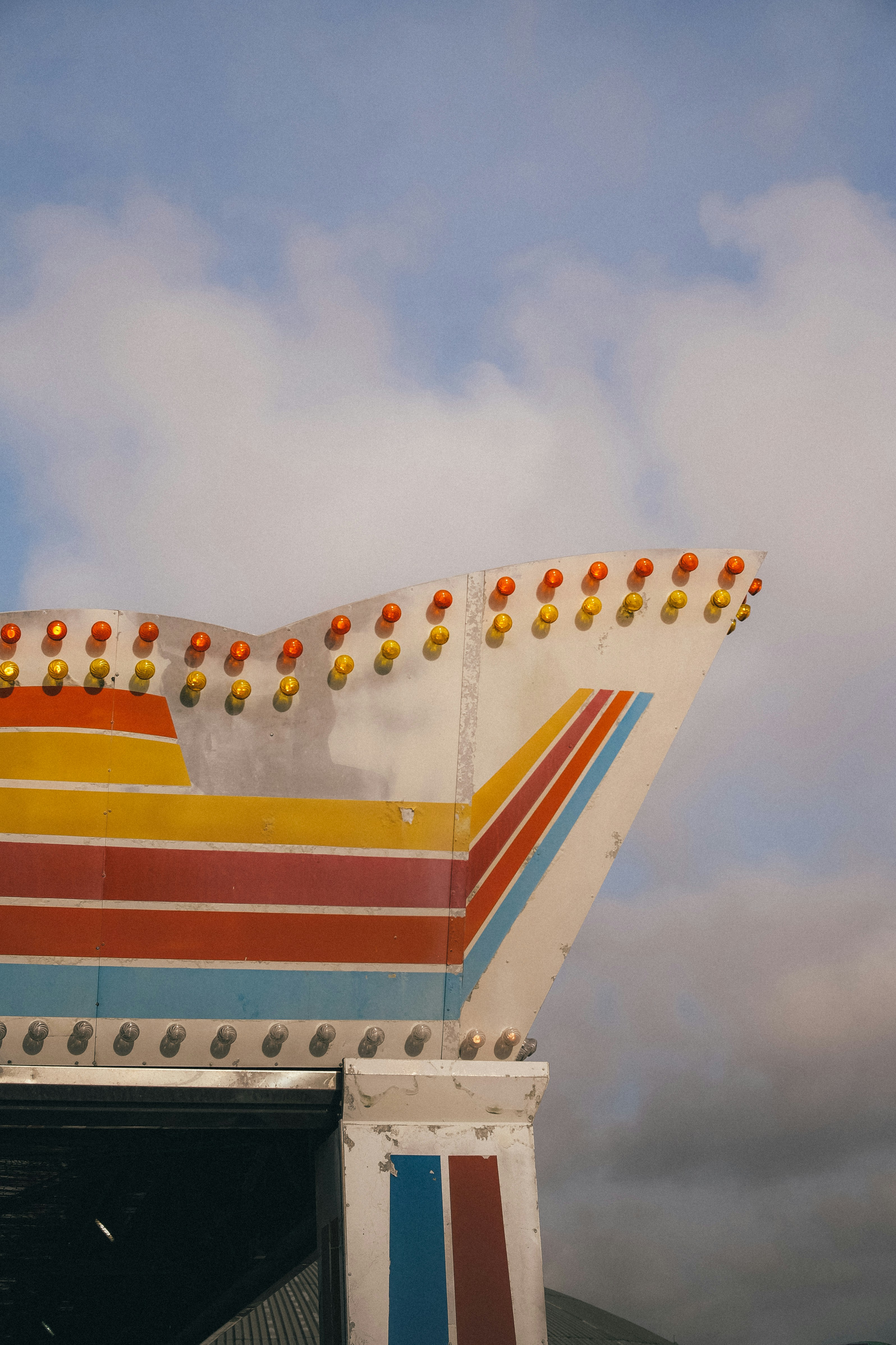 A large colorful structure with a sky in the background
