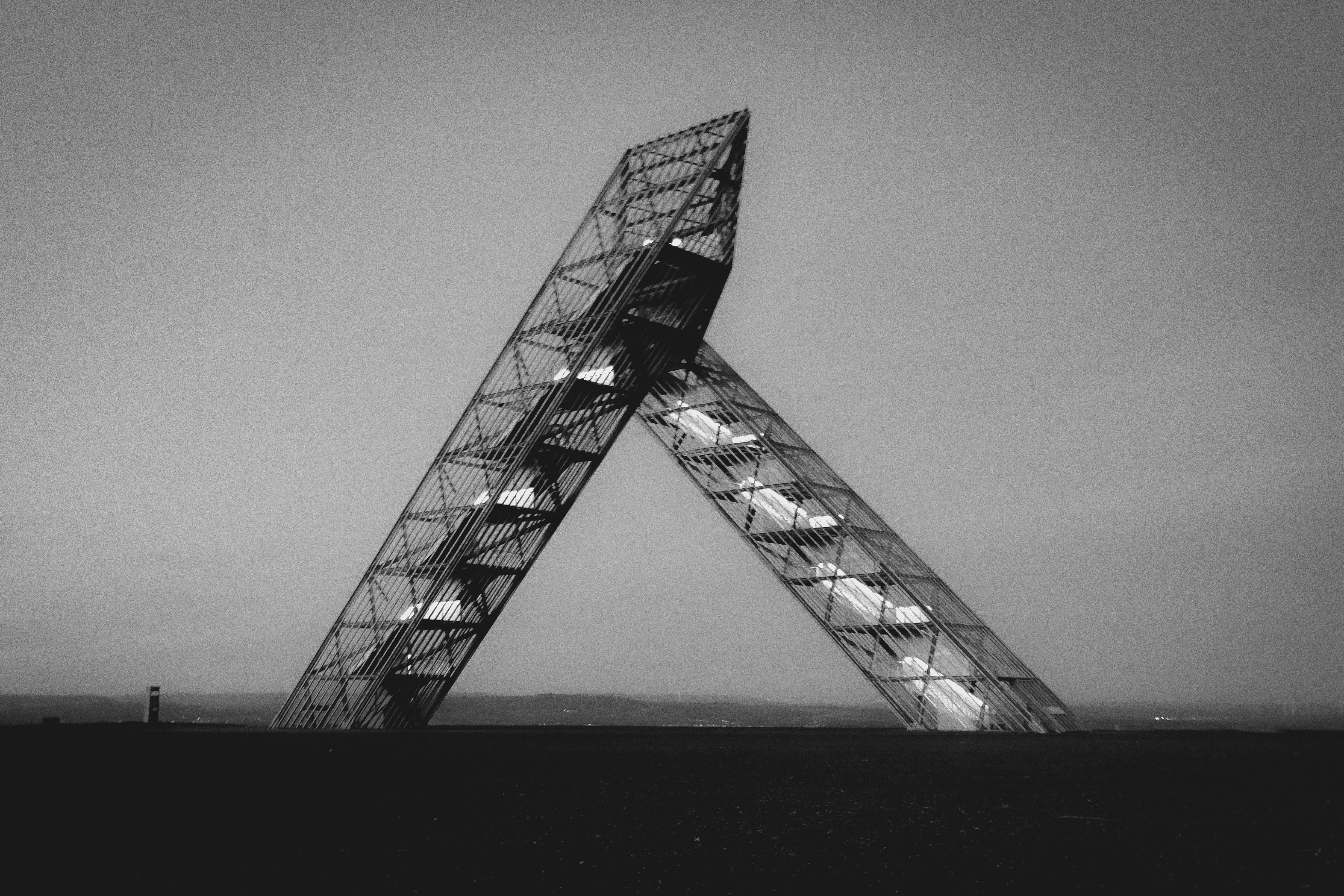 a very tall metal structure in the middle of a field