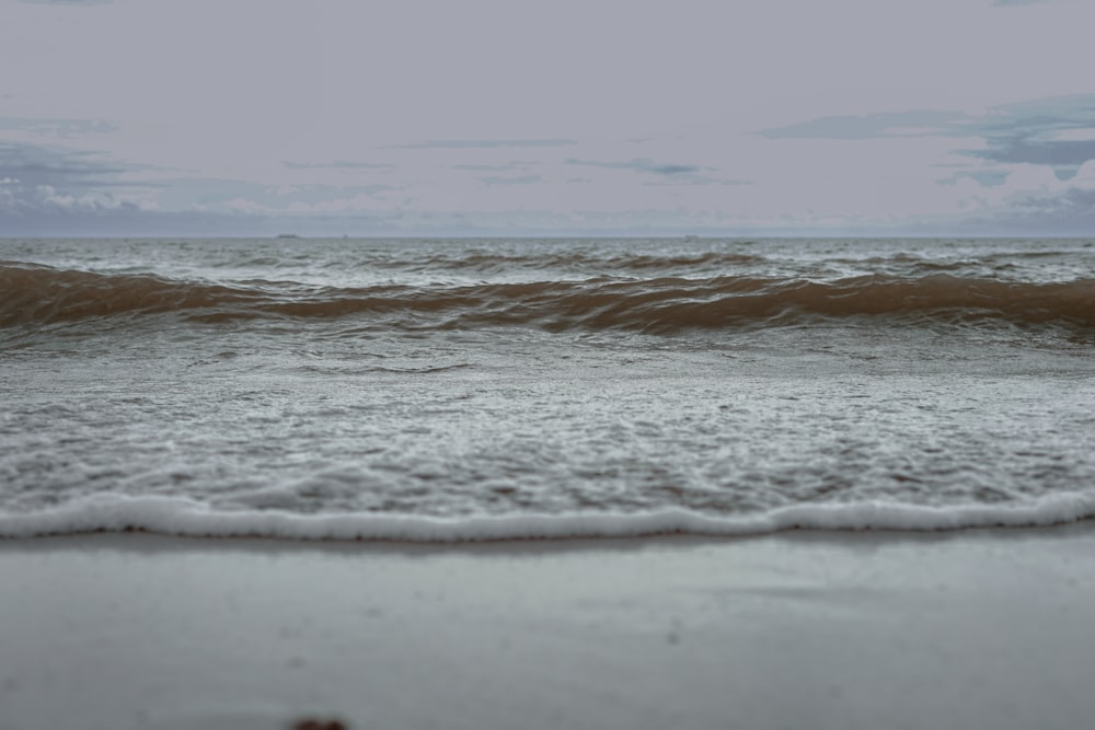 a beach with waves coming in to shore