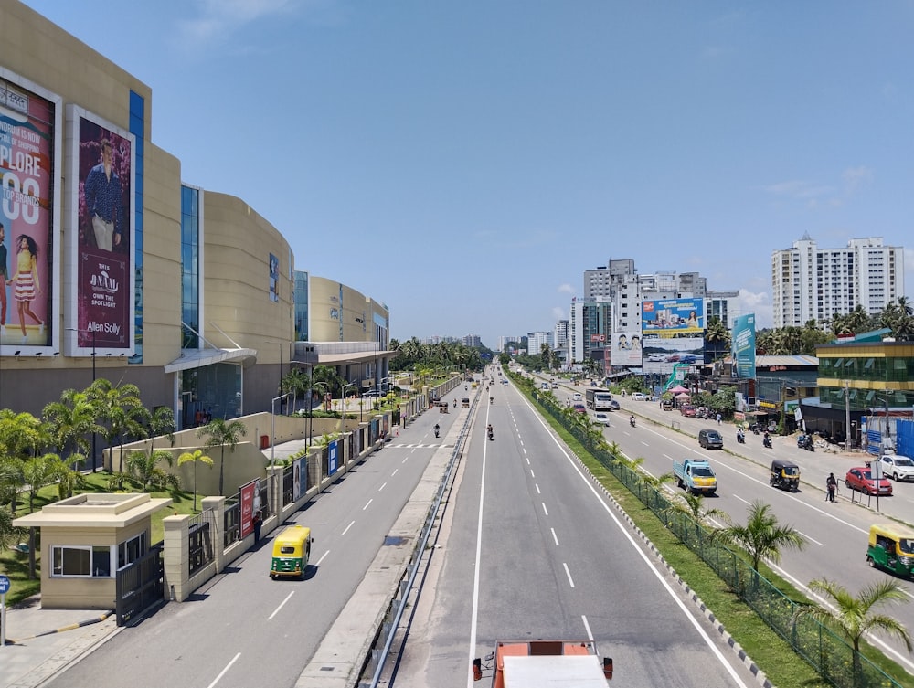 a city street filled with traffic next to tall buildings