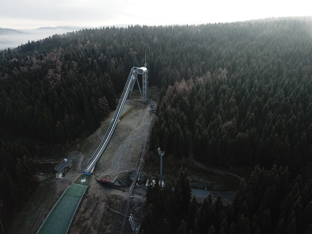 an aerial view of a ski lift in the middle of a forest