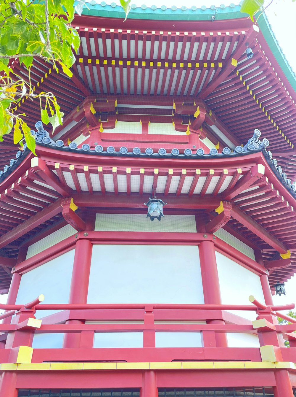 a tall red building with a blue roof