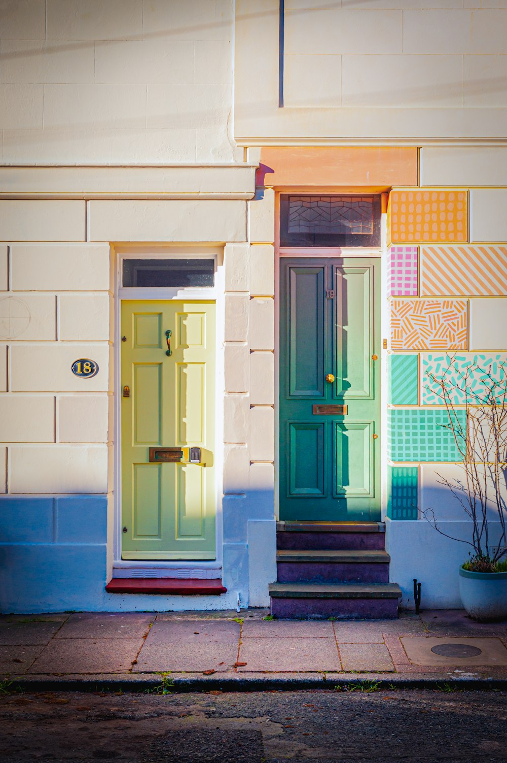 a yellow door and a green door on a building