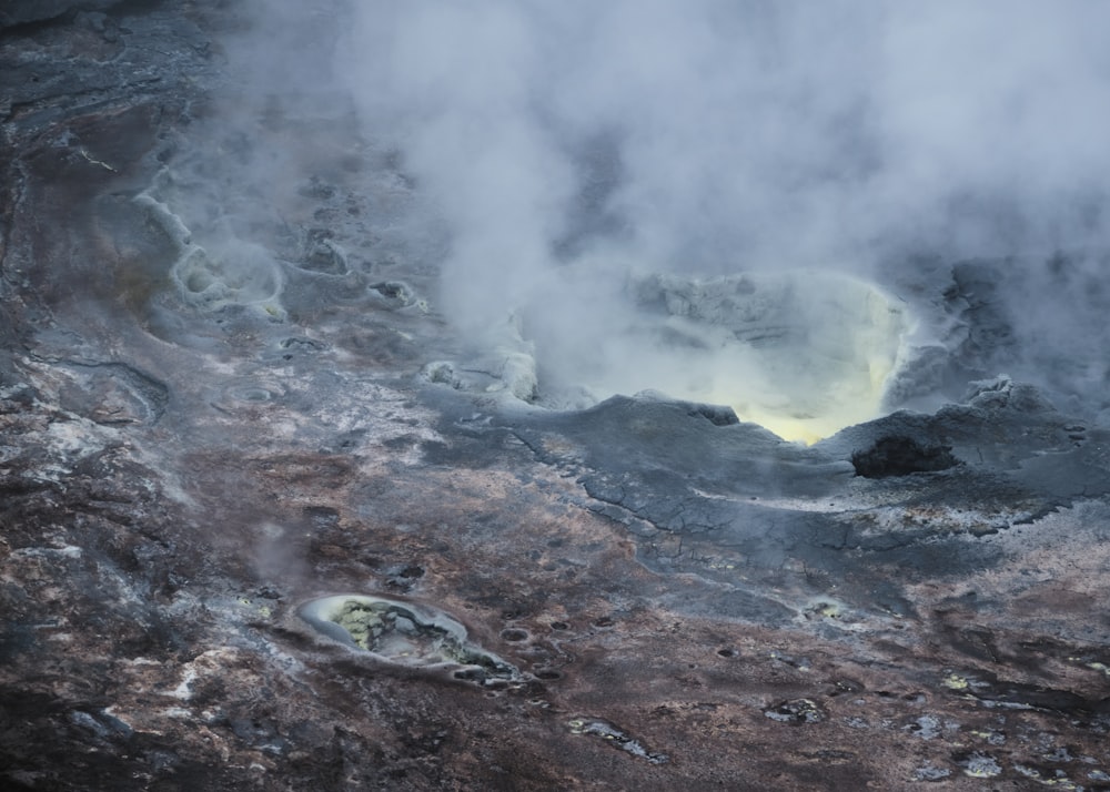 a crater with steam rising out of it