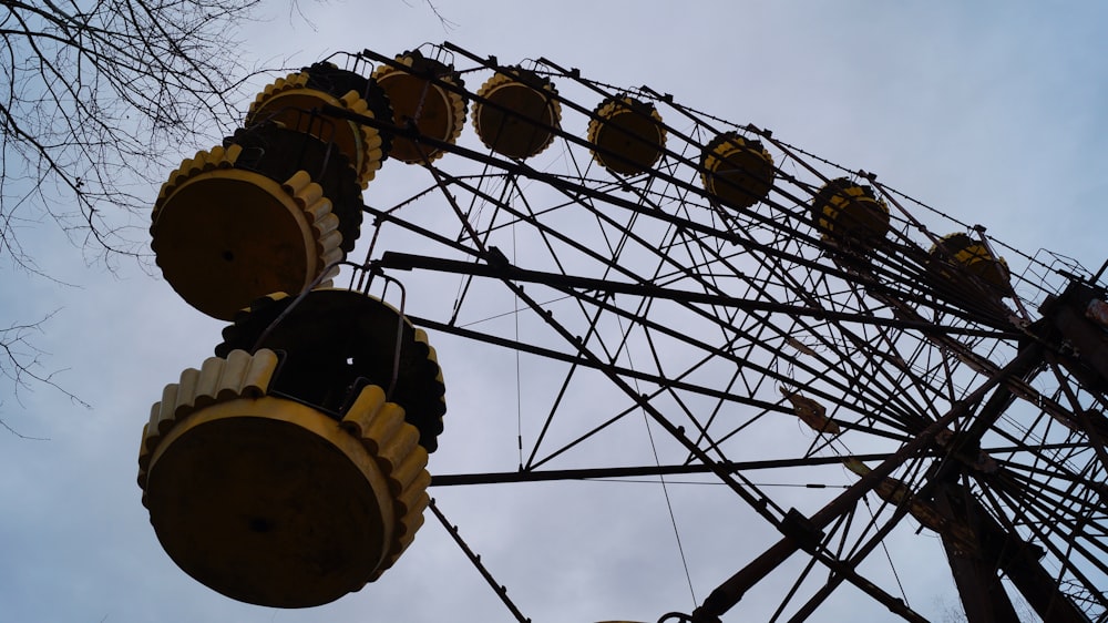 a large ferris wheel sitting next to a tree