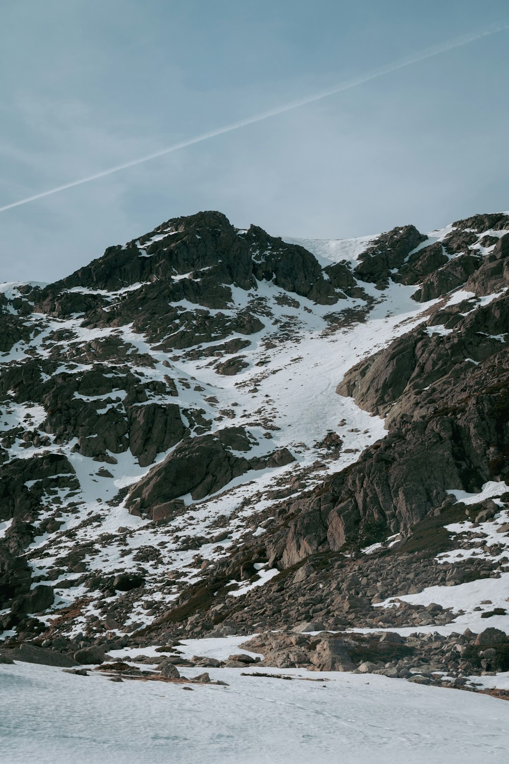 a snow covered mountain with a ski lift in the background