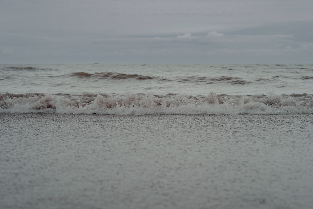 a beach with waves coming in and out of the water