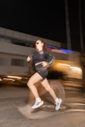 a woman running on a city street at night