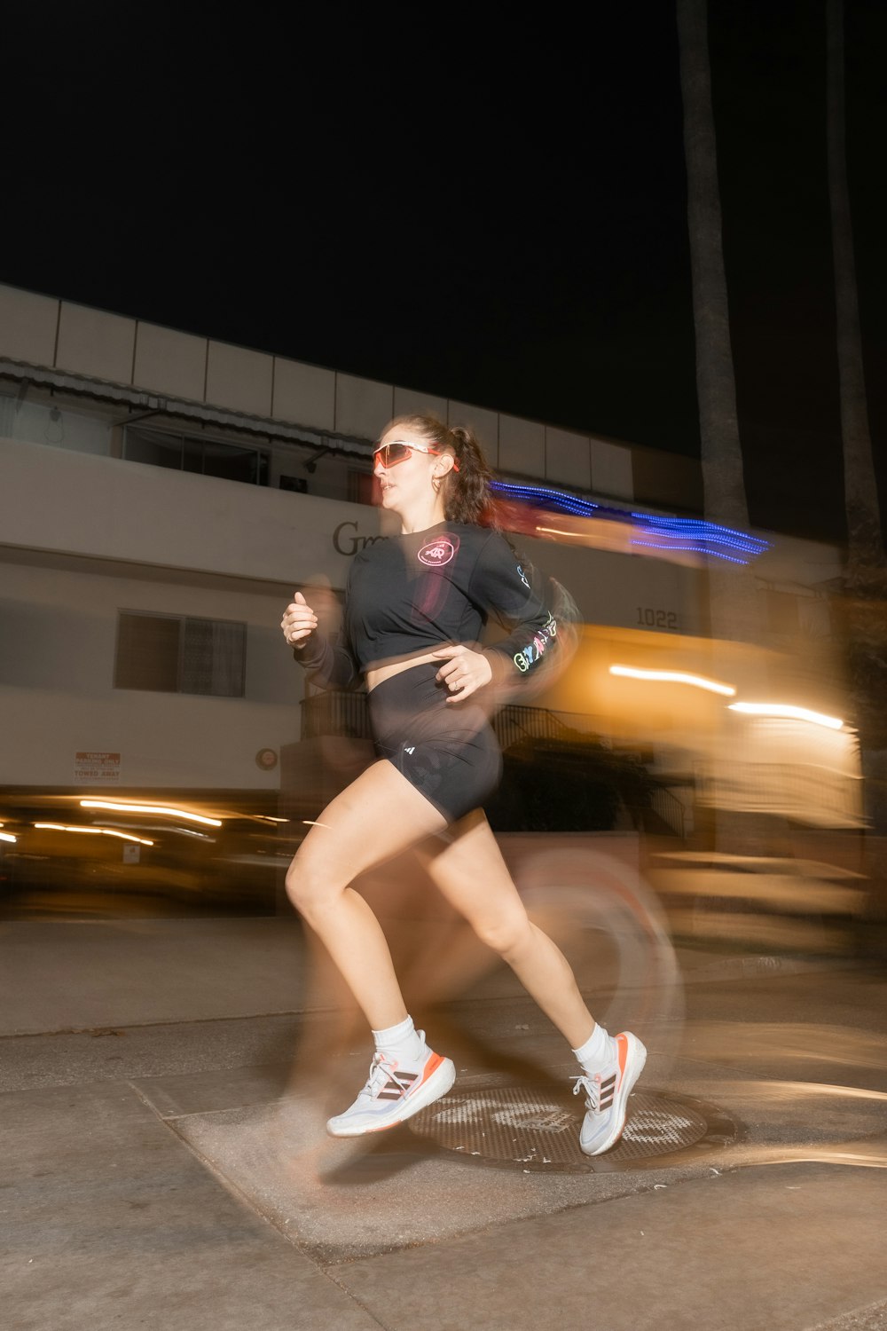 a woman running on a city street at night