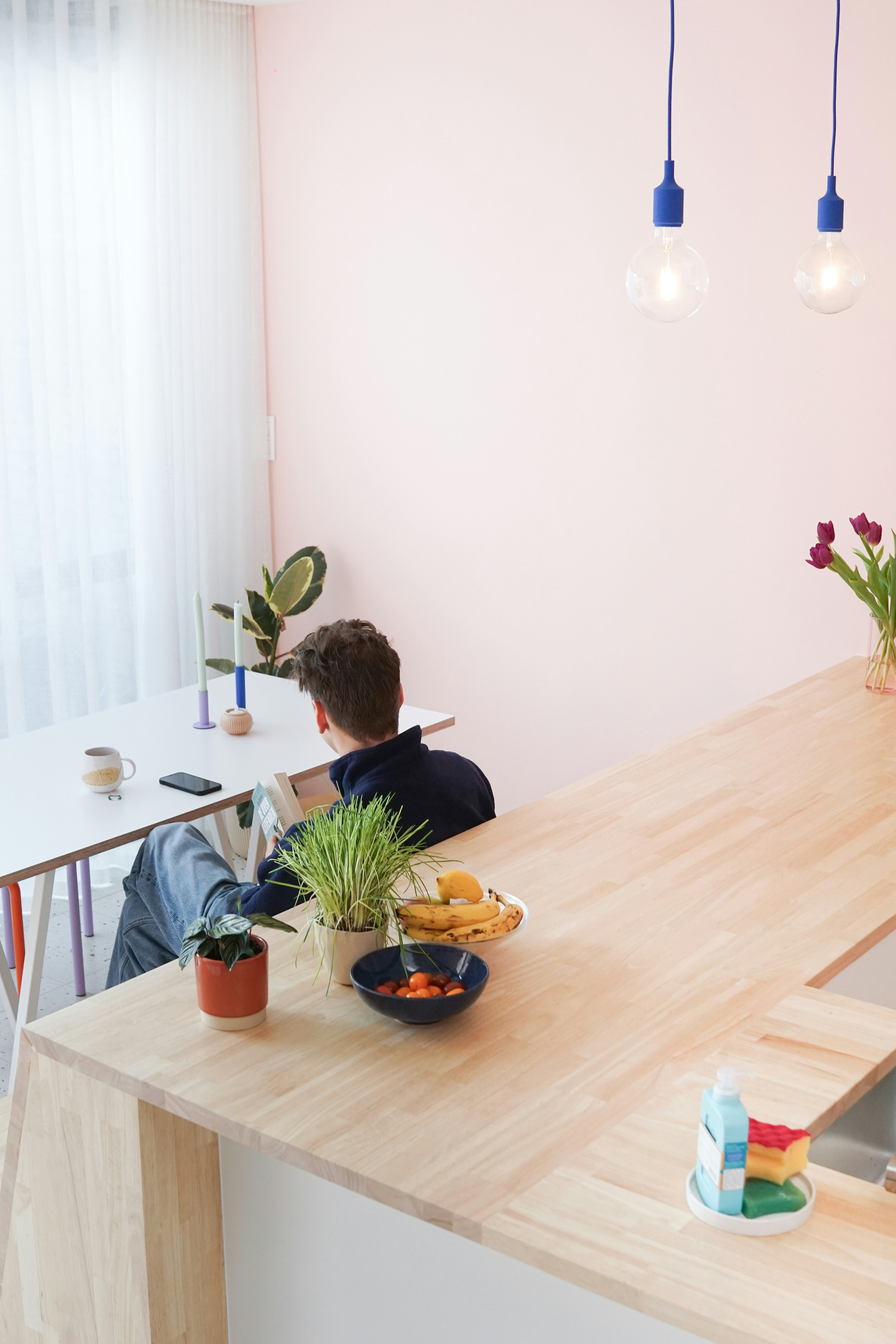 a young boy sitting at a kitchen counter with a plate of food