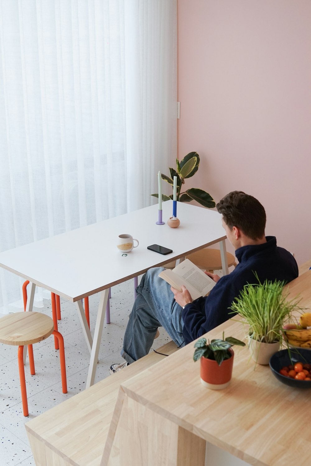 a man sitting at a table reading a book