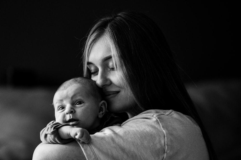 a woman holding a baby in her arms