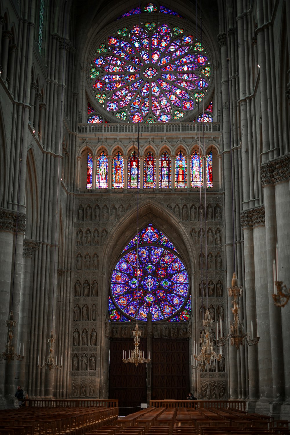 a large cathedral with stained glass windows and pews