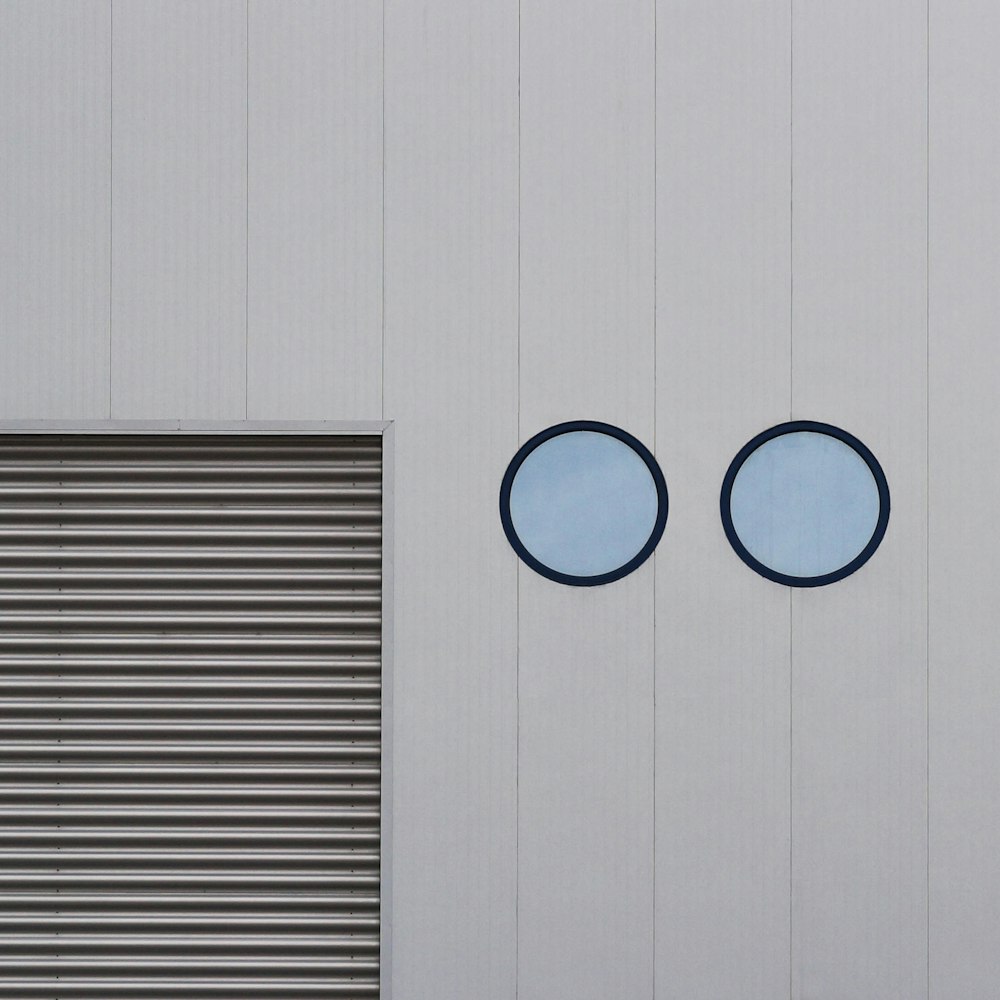 two round windows on the side of a building