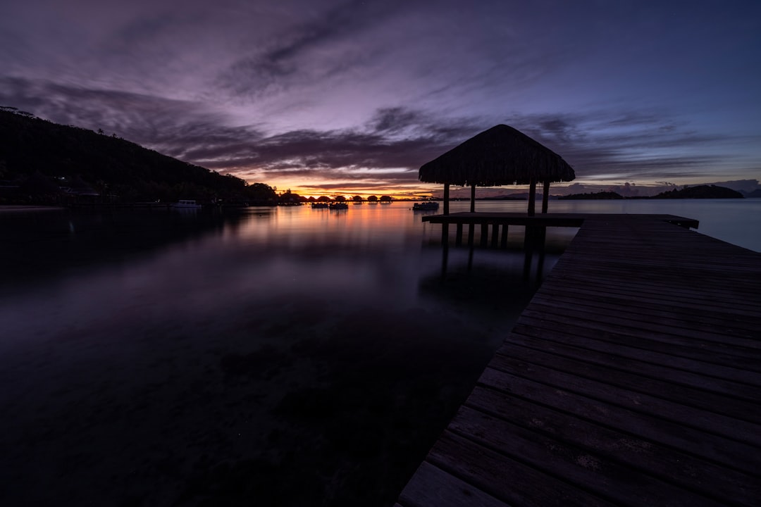 a dock with a hut on it at night,