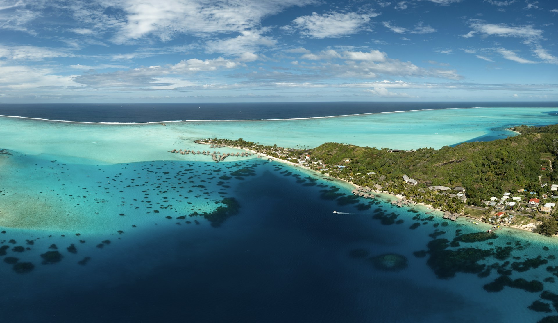 an aerial view of a tropical island in the middle of the ocean