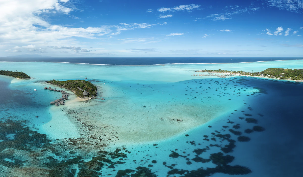Aerial view of the barrier reef and shallow turquoise water around Bora Bora