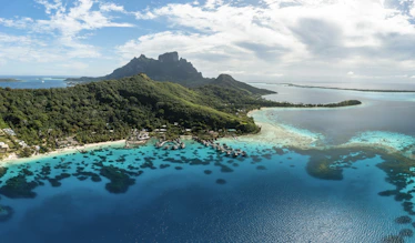 an aerial view of a tropical island in the middle of the ocean