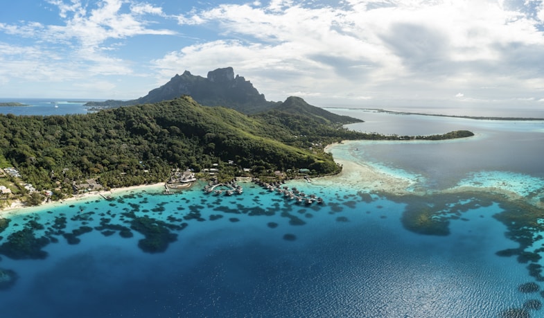 an aerial view of a tropical island in the middle of the ocean