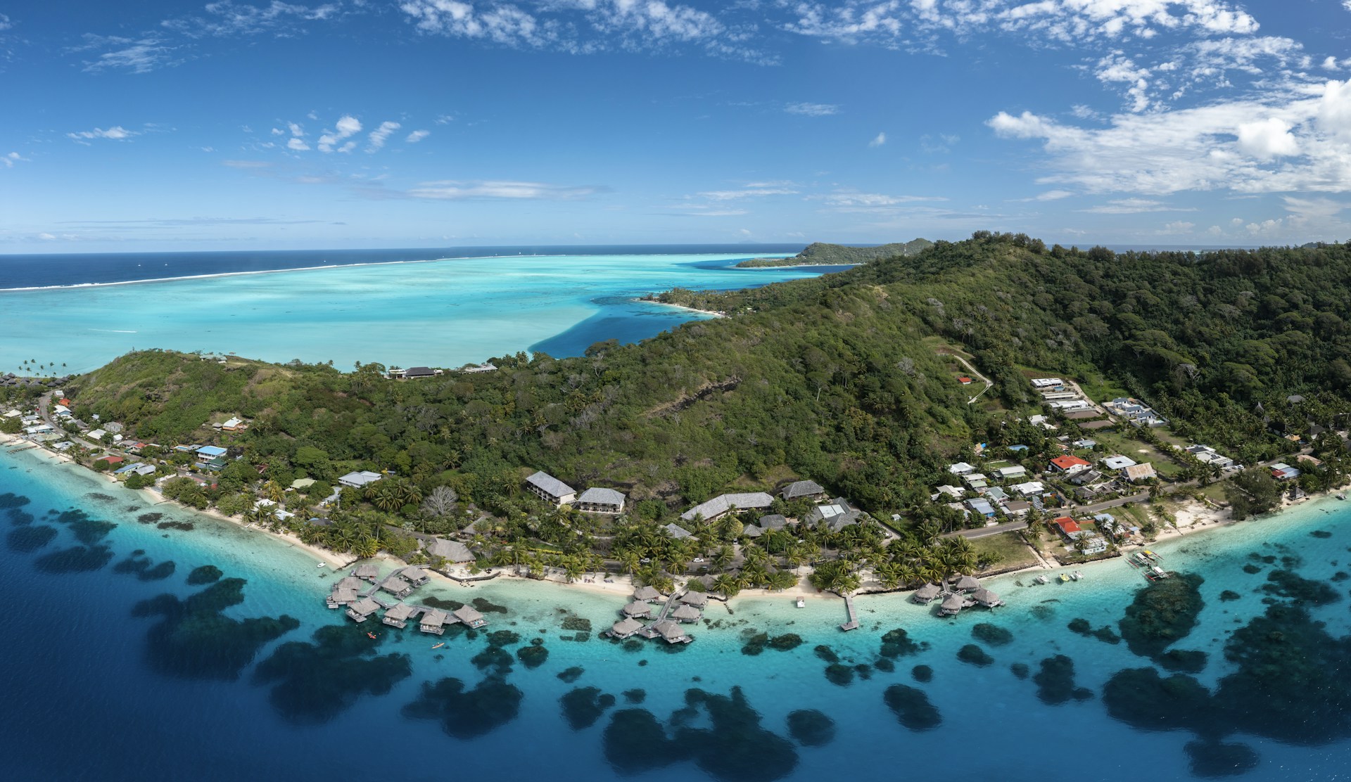 an aerial view of a tropical island in the middle of the ocean
