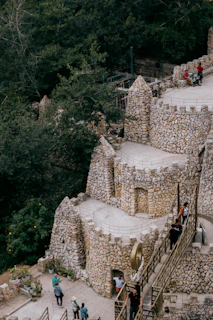a group of people standing on top of a stone building