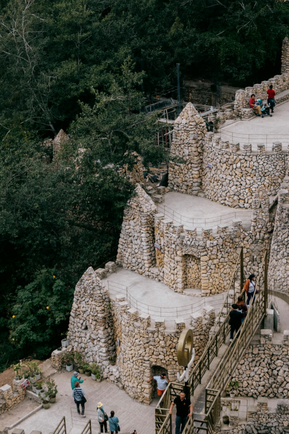 a group of people standing on top of a stone building