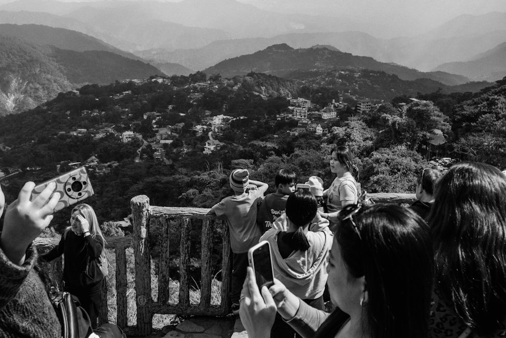 a group of people standing on top of a mountain