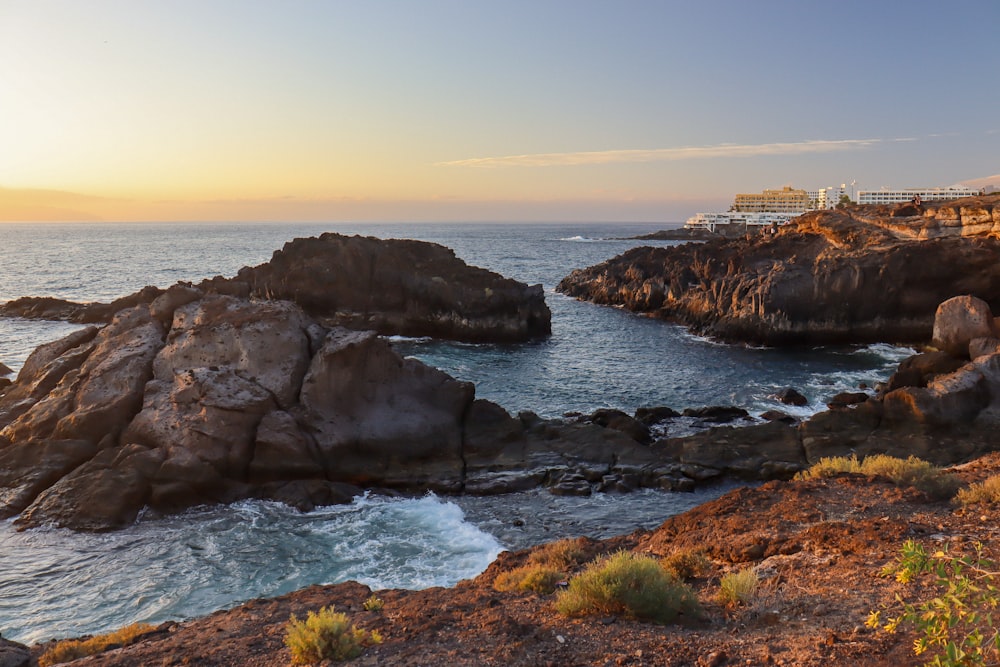 a view of the ocean from a rocky shore