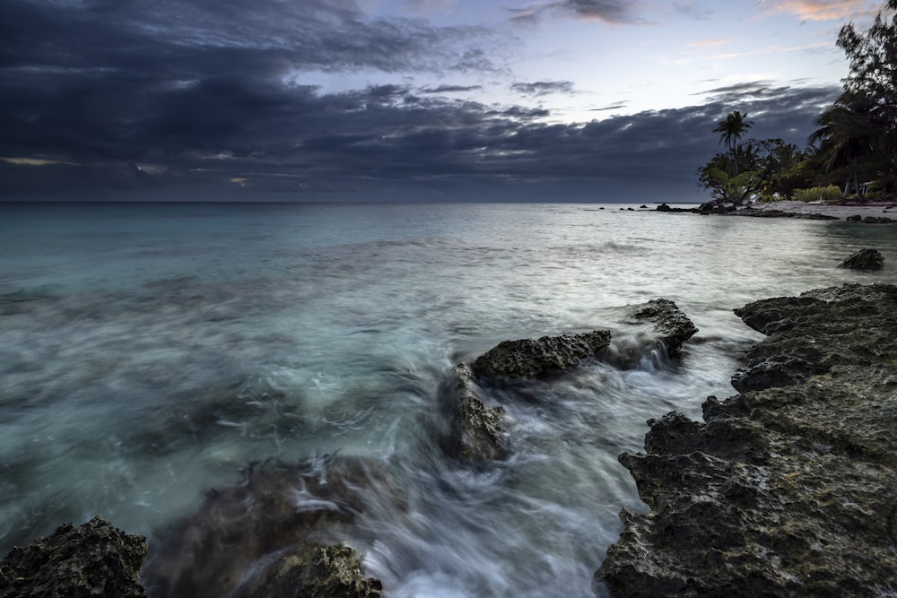 a view of the ocean from a rocky shore