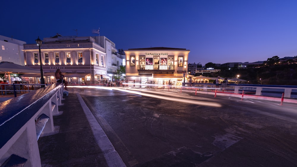 a city street at night with a building in the background