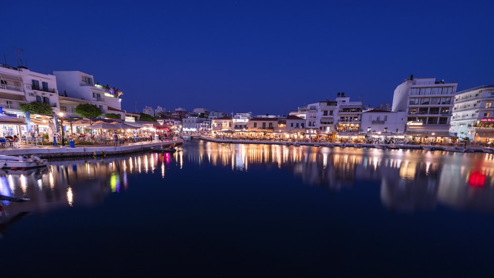 a city at night with lights reflecting in the water