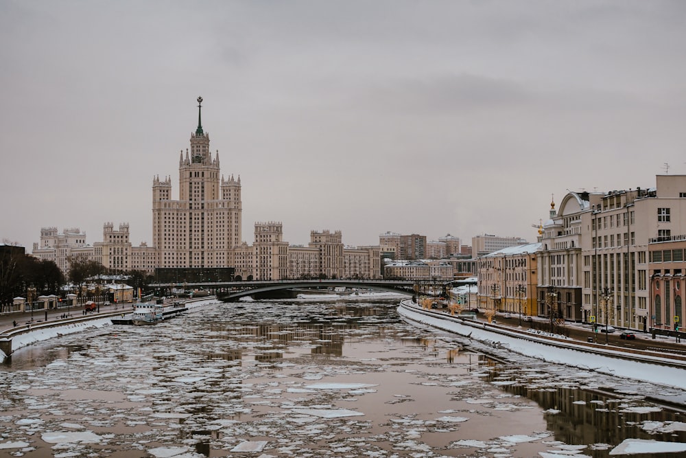 a river running through a city next to tall buildings