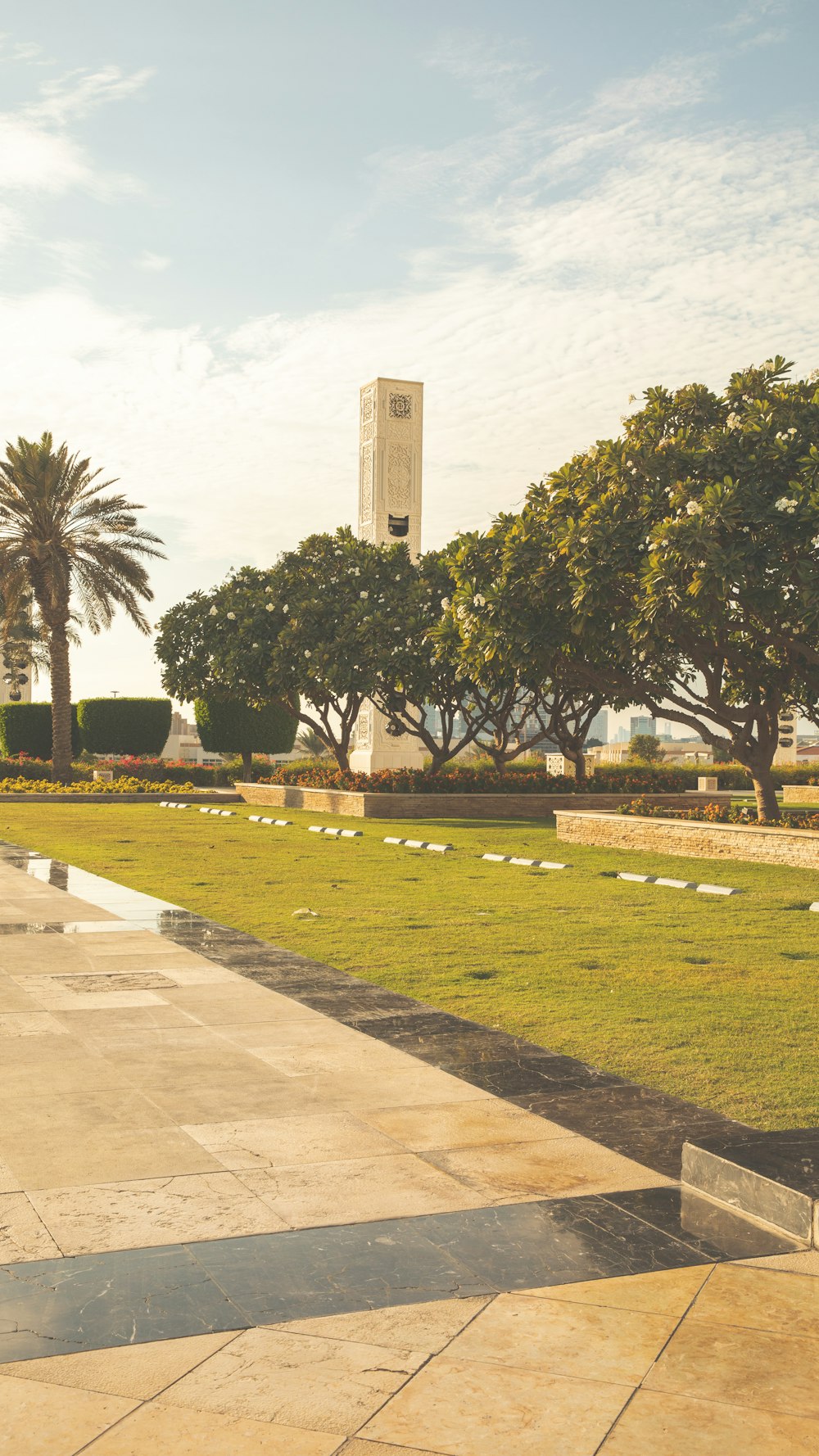 a park with a clock tower in the background