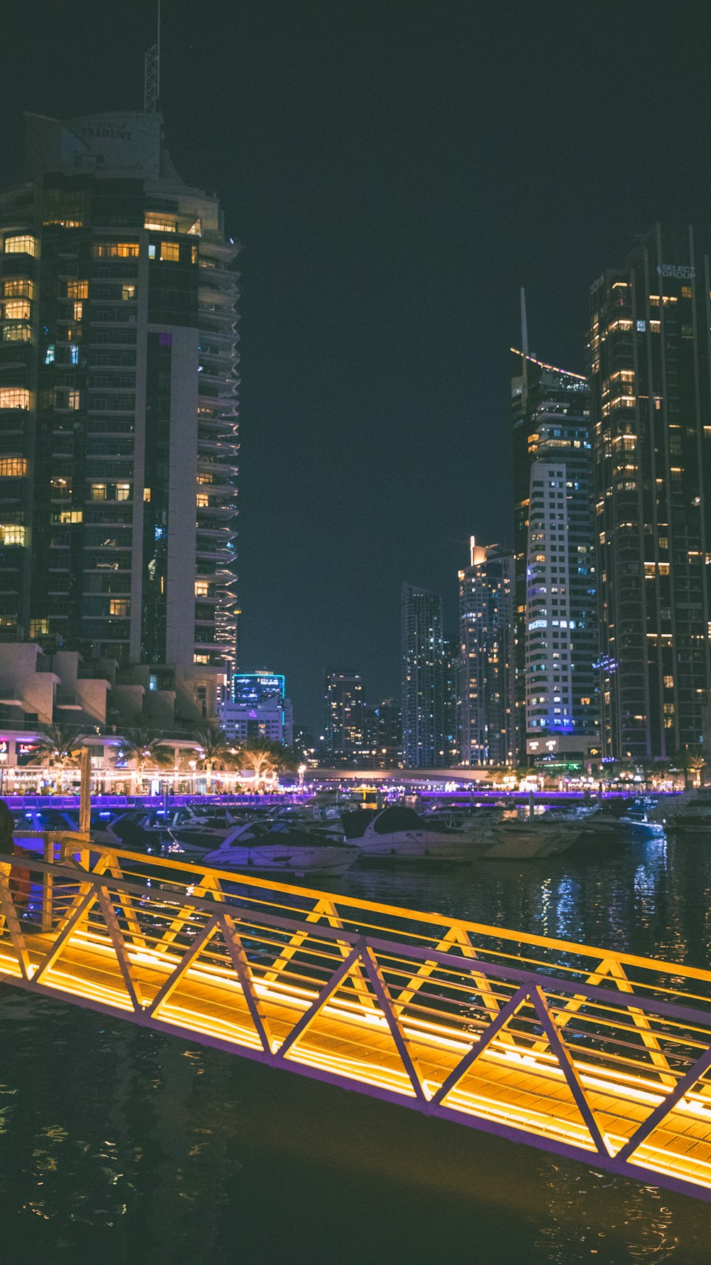 a bridge over a body of water with a city in the background