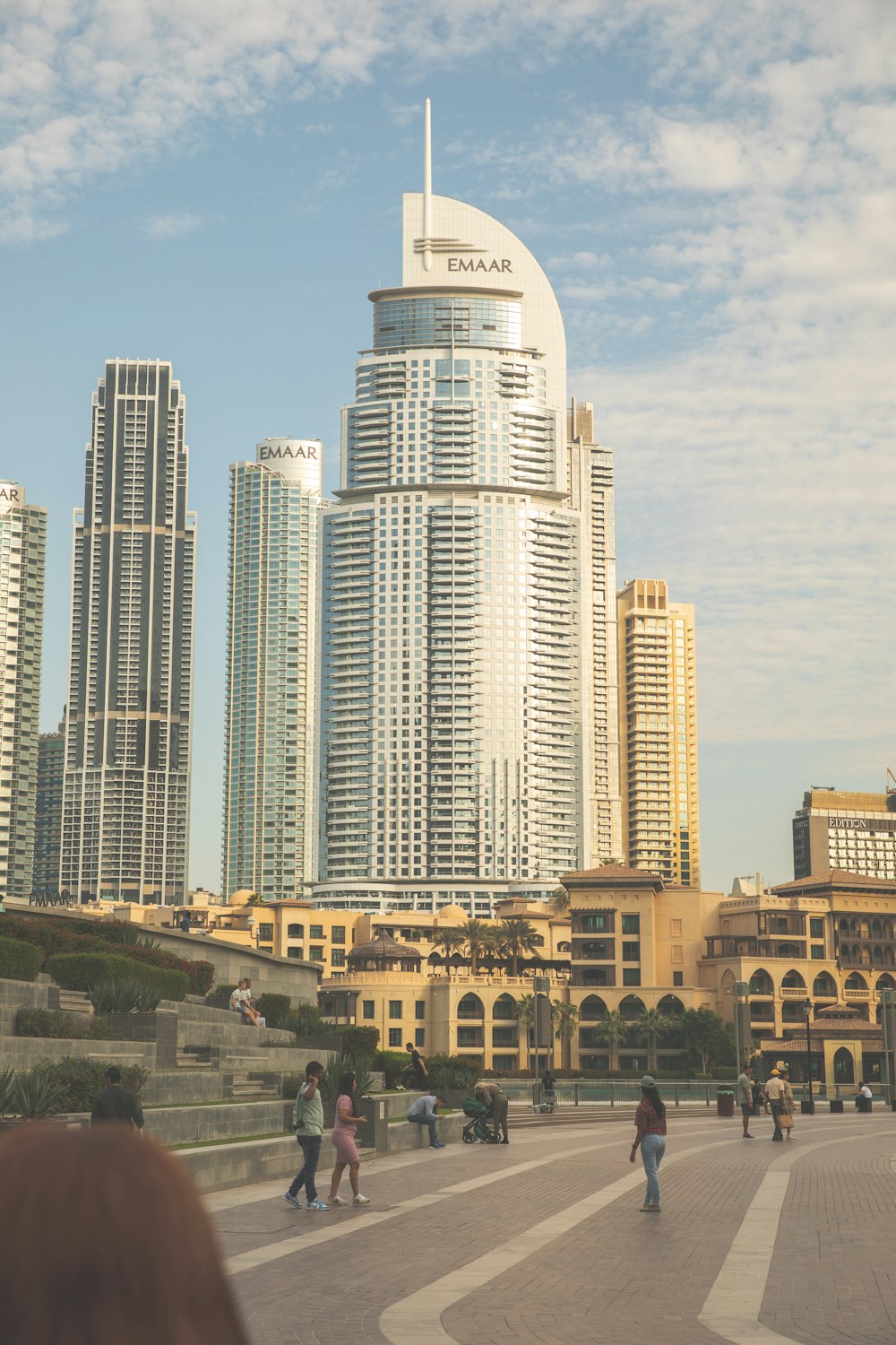 a group of people walking in front of tall buildings