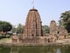 a large stone structure sitting next to a body of water