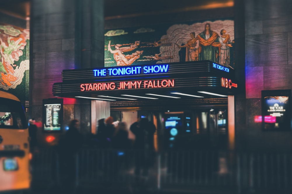 a crowd of people standing outside of a theater