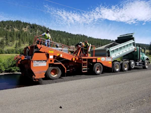 a large truck with a dump truck on the back of it