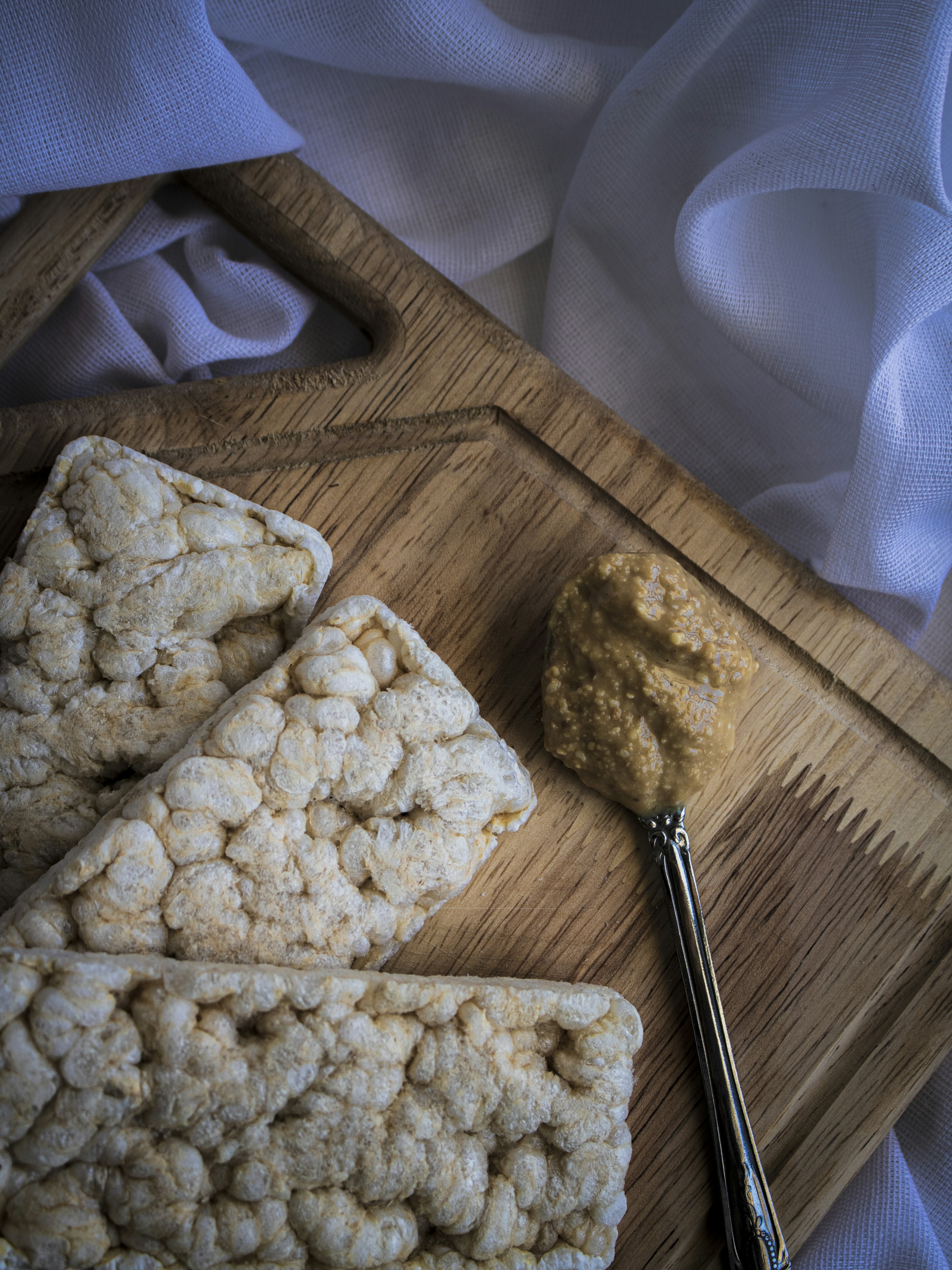 Crispy rice cereal squares dipped in milk chocolate, sprinkled with rose-gold shimmer pearls and pink confetti sprinkles, arranged on white marble, soft golden hour light, gourmet styling