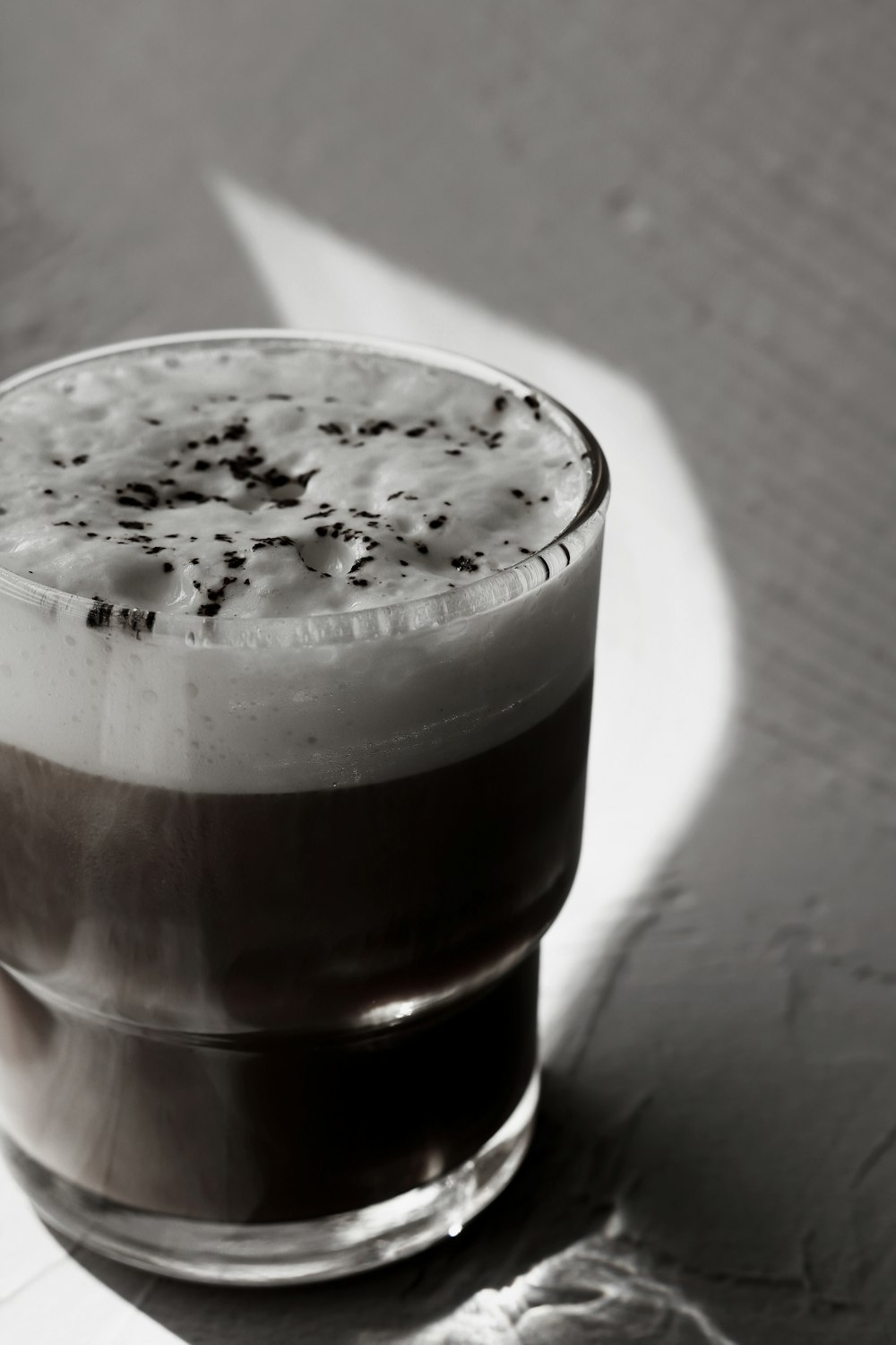 a close up of a drink in a glass on a table