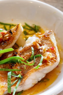 a close up of a plate of food with fish