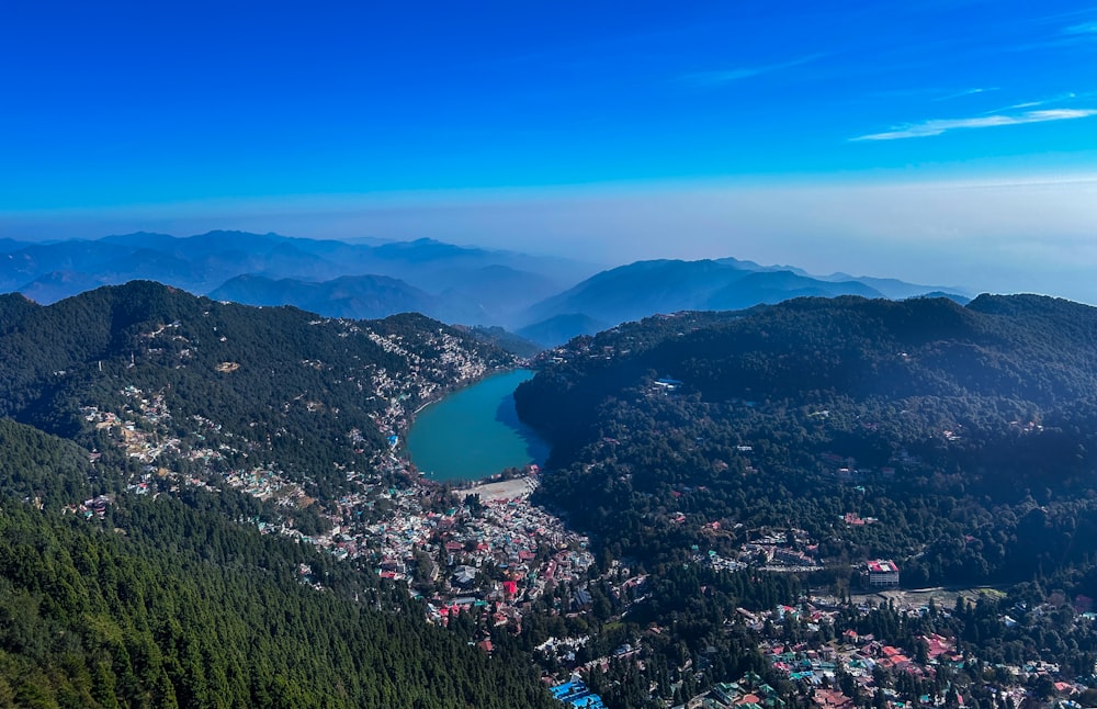 an aerial view of a town and a lake surrounded by mountains