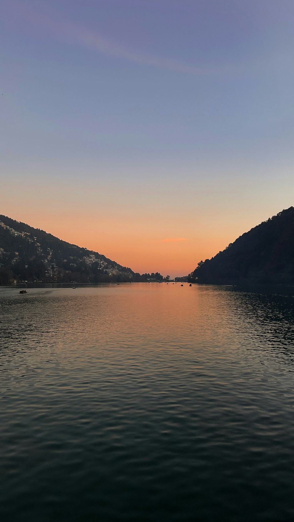 a body of water with mountains in the background