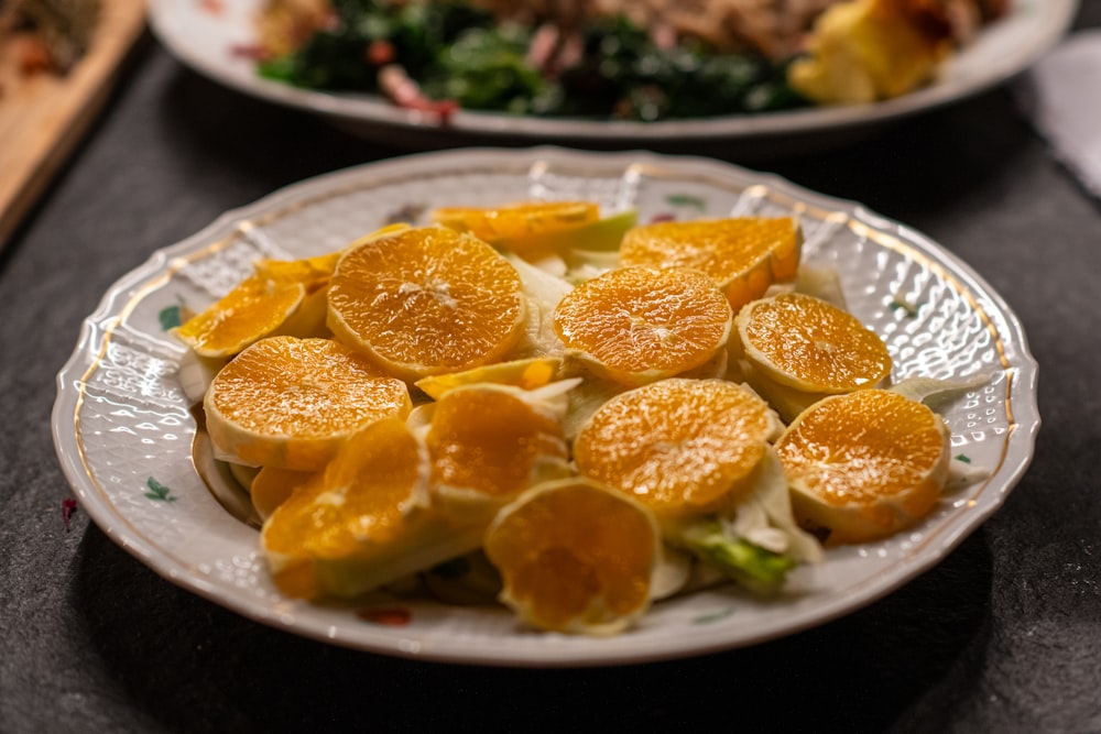 a white plate topped with sliced oranges on top of a table