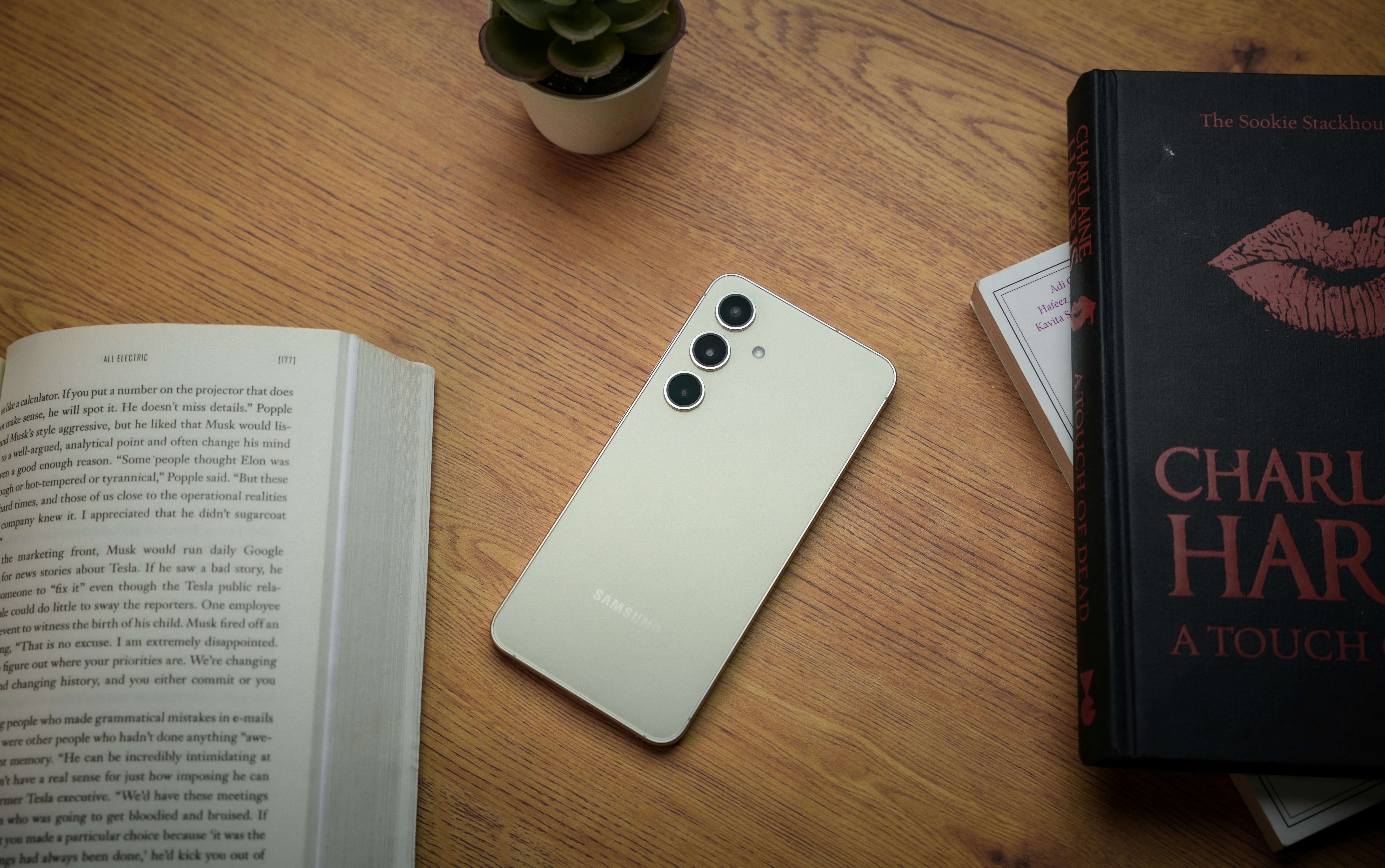 a cell phone sitting on top of a table next to a book