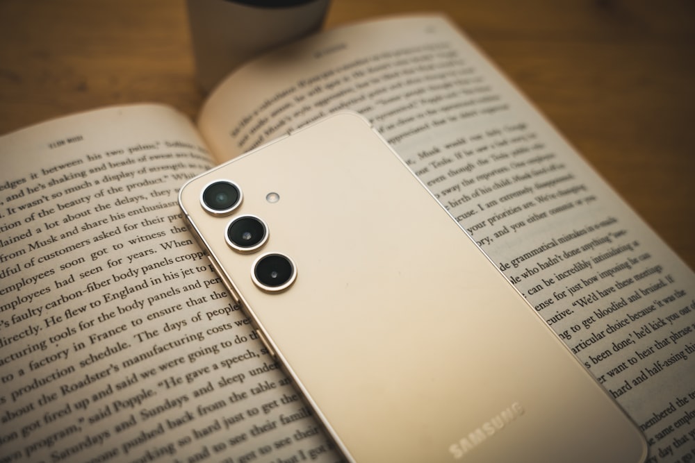 a close up of a cell phone on a book