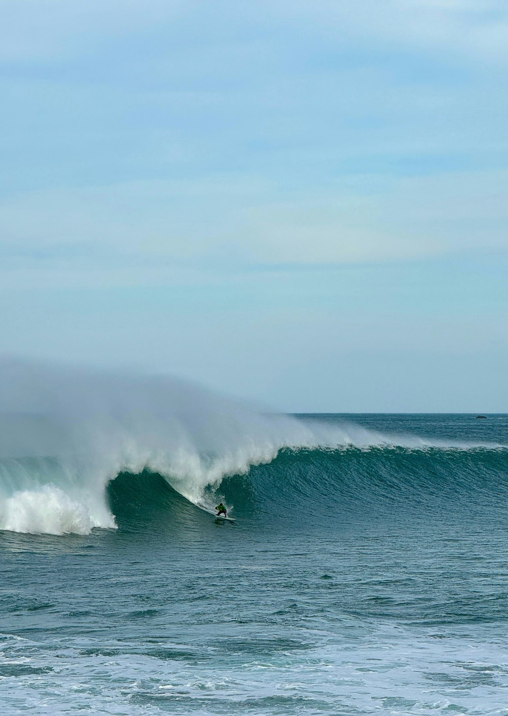 a man riding a wave on top of a surfboard