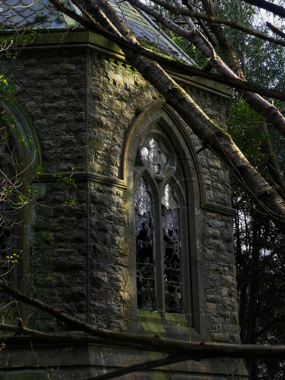an old stone church with a stained glass window